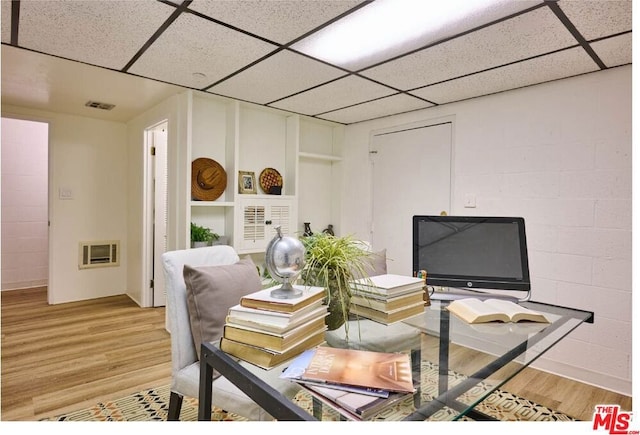 office featuring light wood-type flooring and a paneled ceiling