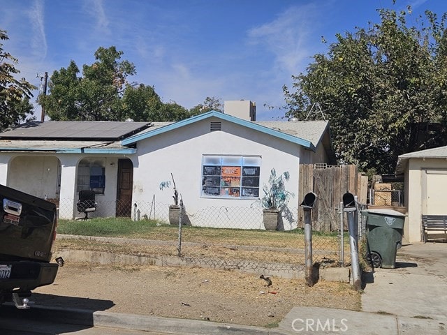 view of front of home featuring solar panels