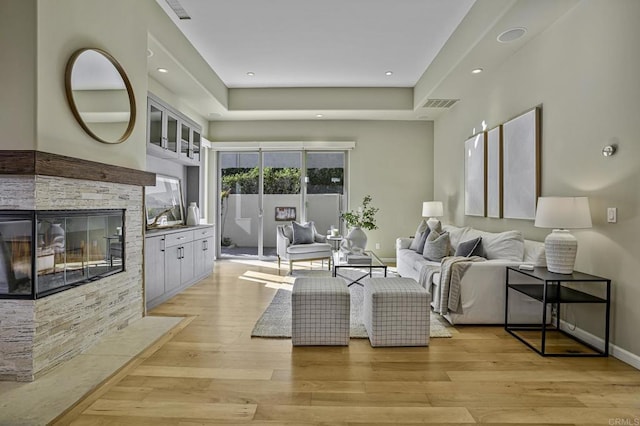 living room featuring a fireplace and light wood-type flooring