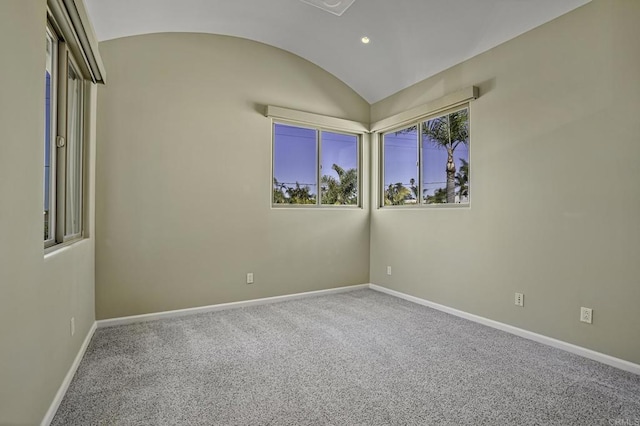 unfurnished room featuring vaulted ceiling and carpet floors