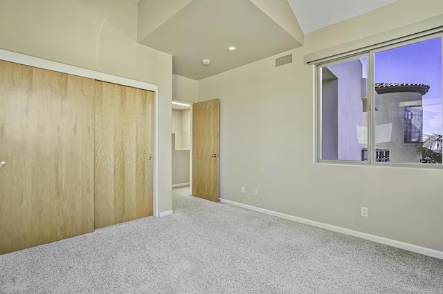 unfurnished bedroom featuring carpet flooring and a closet