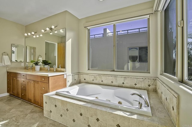 bathroom with a relaxing tiled tub and vanity