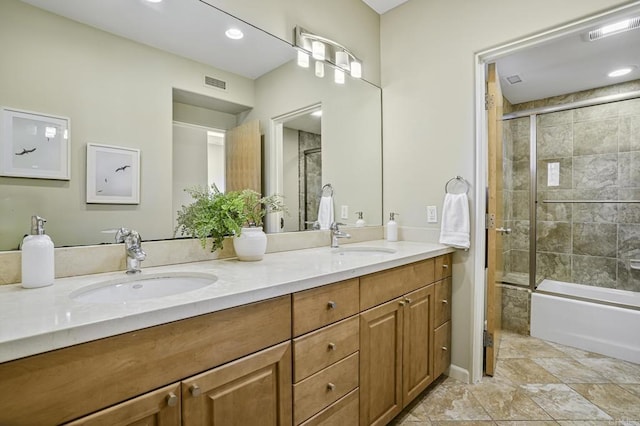 bathroom featuring vanity and combined bath / shower with glass door