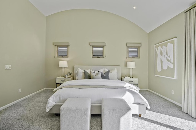 bedroom featuring lofted ceiling and light carpet