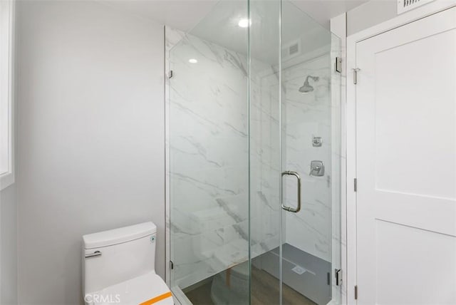 bathroom with toilet and walk in shower