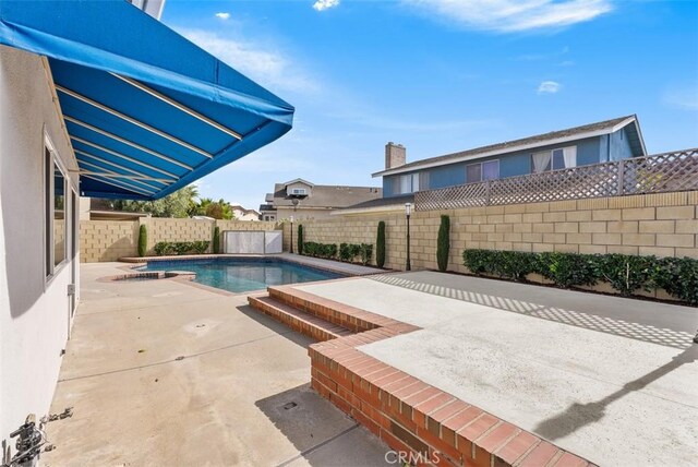 view of swimming pool with a patio