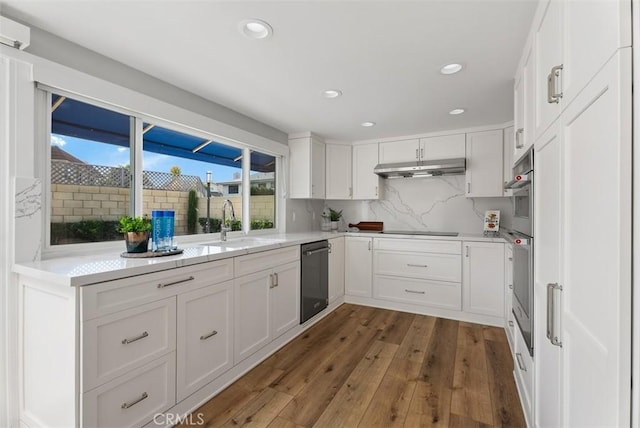 kitchen with white cabinets, dark hardwood / wood-style flooring, and sink