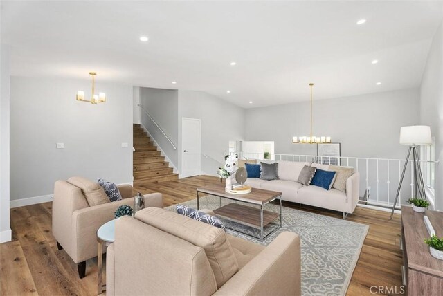 living room featuring light hardwood / wood-style flooring and an inviting chandelier