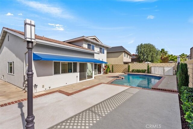 back of house featuring a fenced in pool and a patio area