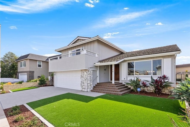 split level home featuring a balcony, a front yard, and a garage