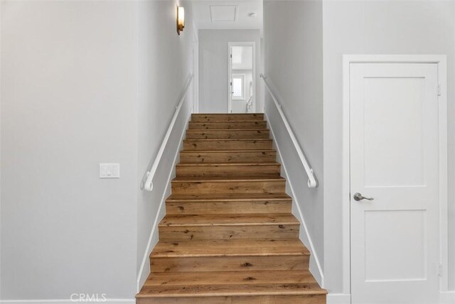 stairs with wood-type flooring