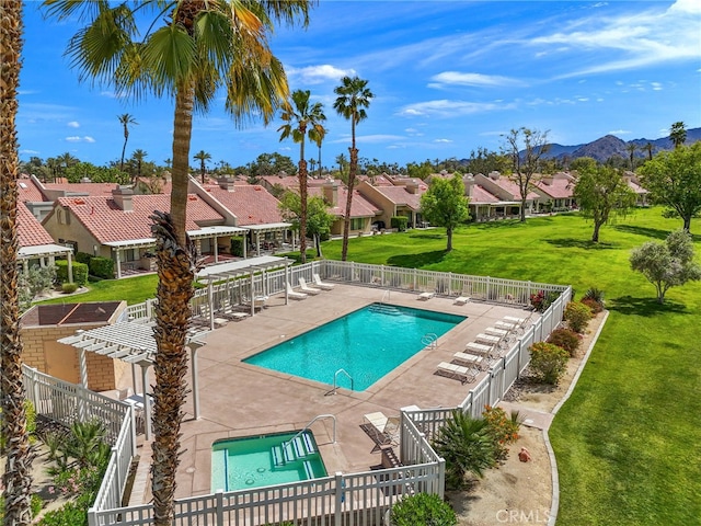 view of swimming pool featuring a mountain view, a pergola, a patio, and a yard