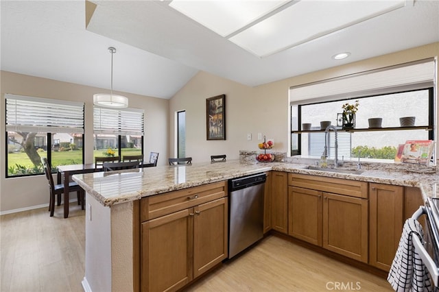 kitchen featuring kitchen peninsula, sink, dishwasher, light hardwood / wood-style floors, and hanging light fixtures