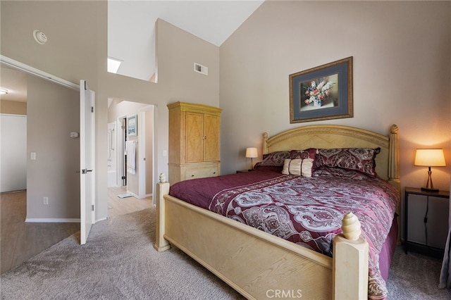 bedroom featuring light carpet and high vaulted ceiling