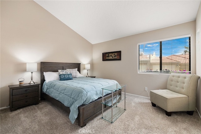 carpeted bedroom with lofted ceiling