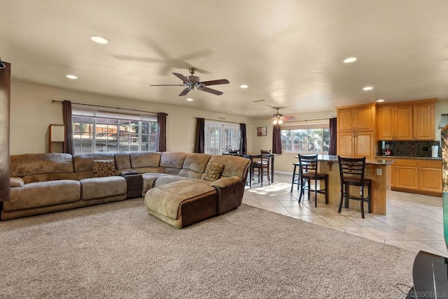 tiled living room featuring ceiling fan