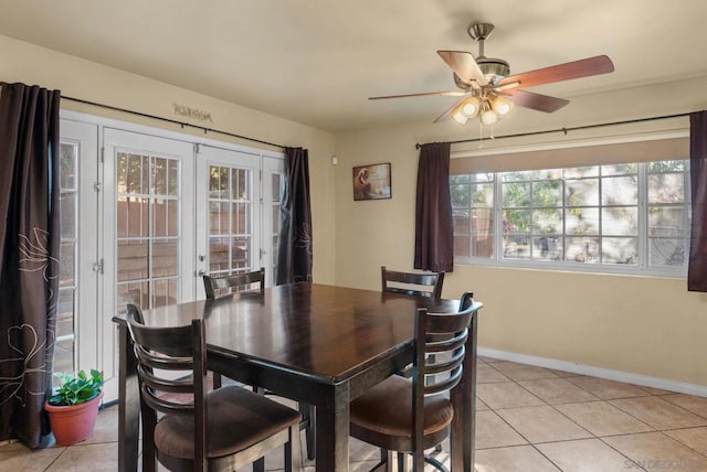 dining room featuring french doors, light tile patterned floors, plenty of natural light, and ceiling fan