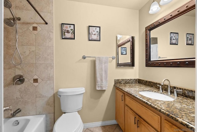 full bathroom with tiled shower / bath, tile patterned flooring, vanity, and toilet