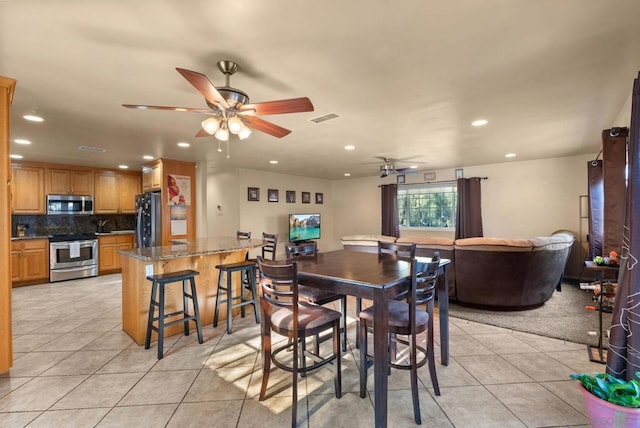 dining room featuring ceiling fan and light tile patterned floors