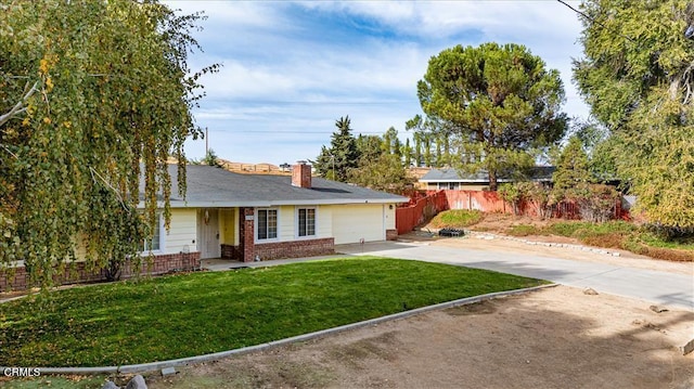 ranch-style house featuring a garage and a front lawn