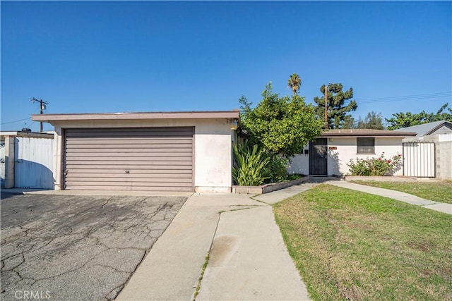 single story home with a front lawn and a garage