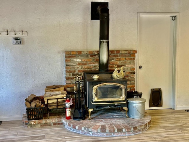 interior details featuring hardwood / wood-style flooring and a wood stove