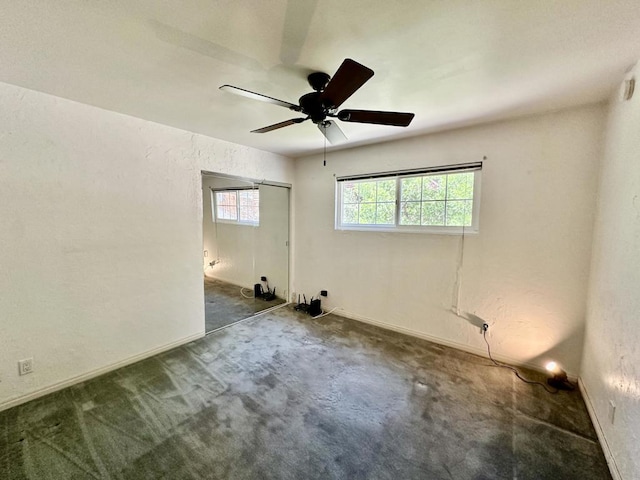 carpeted spare room with ceiling fan