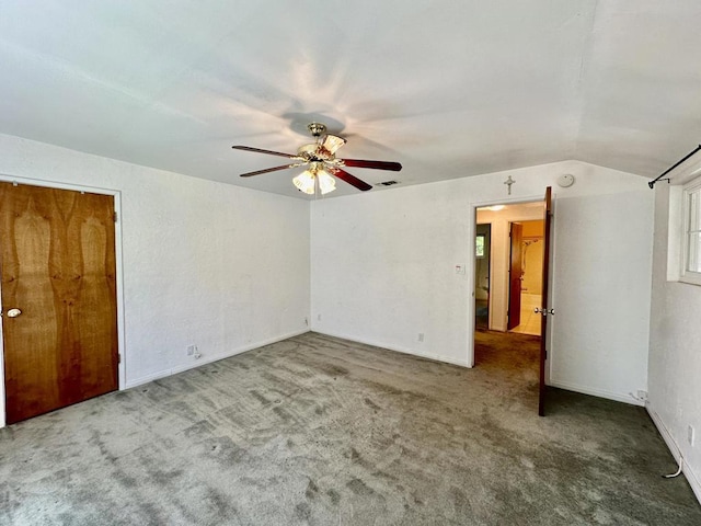 carpeted empty room featuring ceiling fan and lofted ceiling