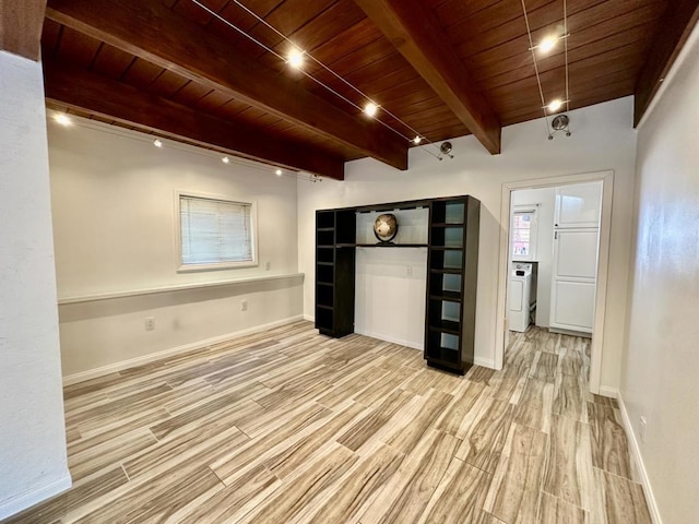 interior space featuring light hardwood / wood-style floors, beam ceiling, wood ceiling, and washer / clothes dryer