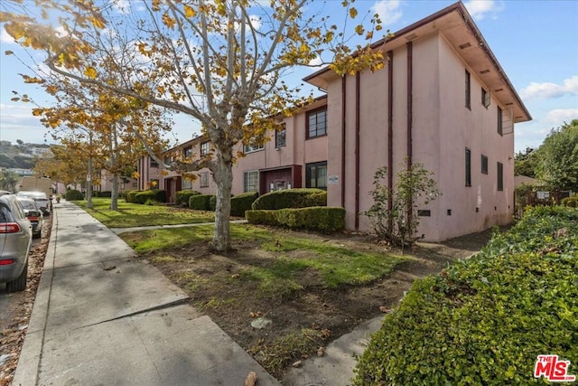 view of side of property with a yard