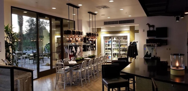 bar featuring hardwood / wood-style floors and pendant lighting