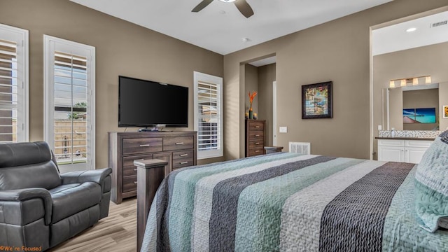 bedroom with light hardwood / wood-style floors and ceiling fan