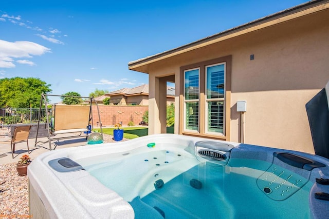 view of pool with a patio and a hot tub