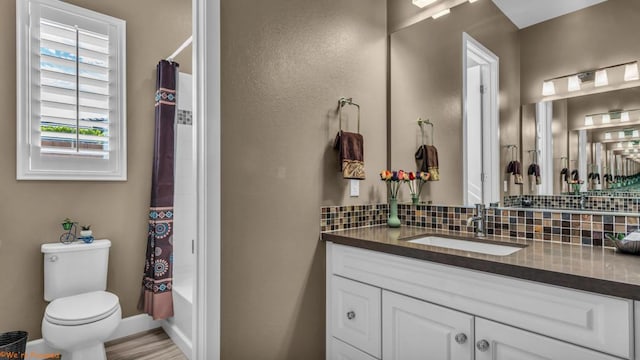 full bathroom with shower / bath combination with curtain, vanity, toilet, and backsplash