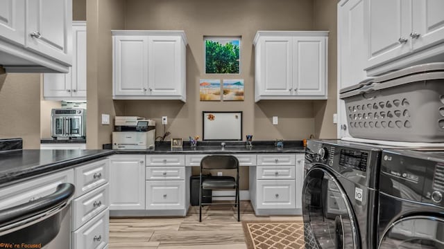 clothes washing area featuring washer and clothes dryer and cabinets