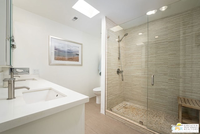 bathroom featuring vanity, an enclosed shower, and toilet