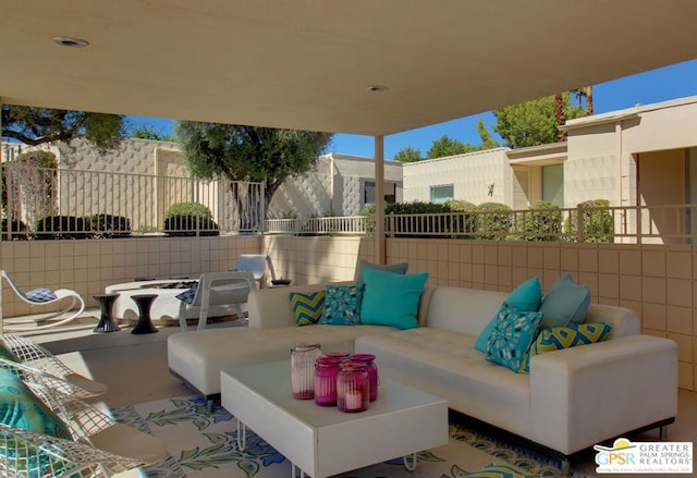 view of patio with an outdoor living space with a fire pit