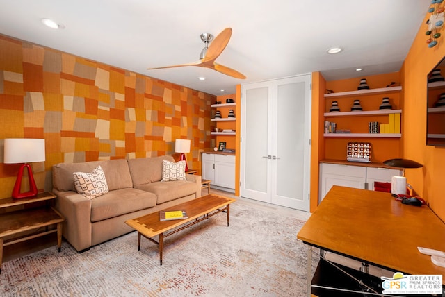 living room featuring ceiling fan and built in features