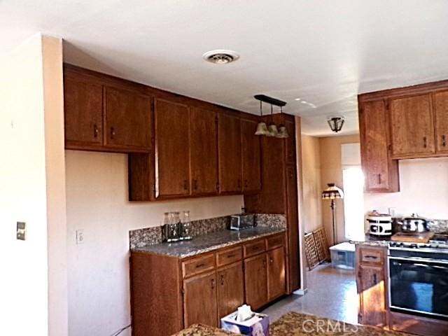 kitchen featuring gas range gas stove and hanging light fixtures