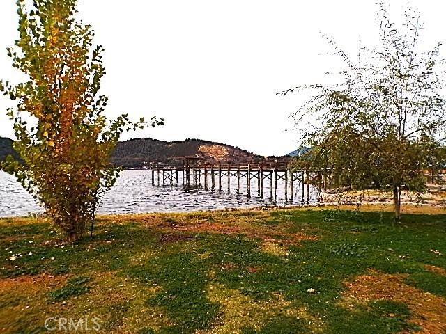 view of dock featuring a water and mountain view