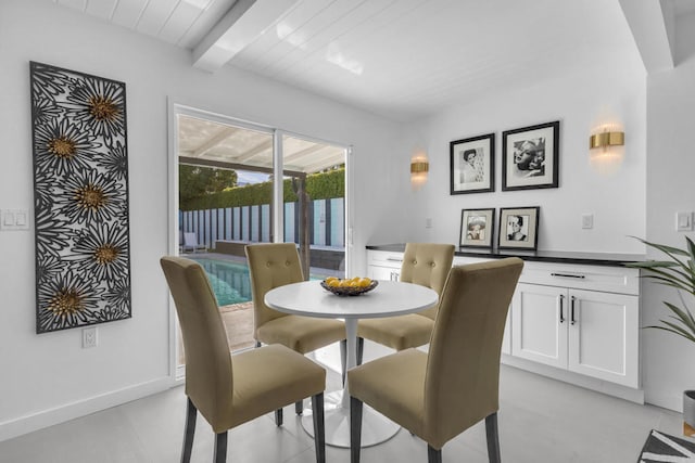 dining space with beam ceiling