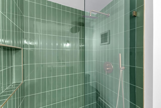 bathroom with tiled shower