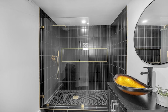 bathroom featuring vanity and tiled shower