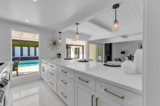 kitchen featuring white cabinetry, hanging light fixtures, wooden ceiling, and beamed ceiling