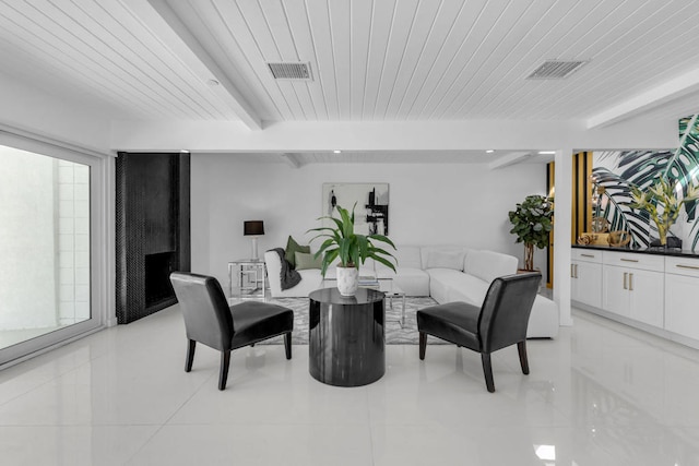 tiled dining space with wood ceiling and beam ceiling