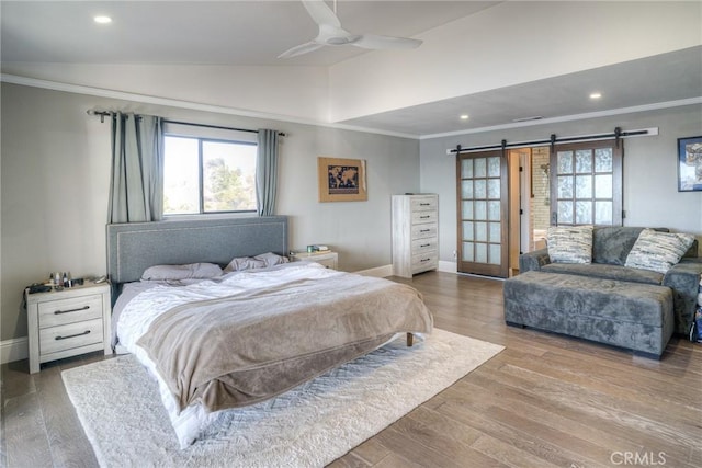 bedroom featuring hardwood / wood-style flooring, ceiling fan, ornamental molding, and vaulted ceiling