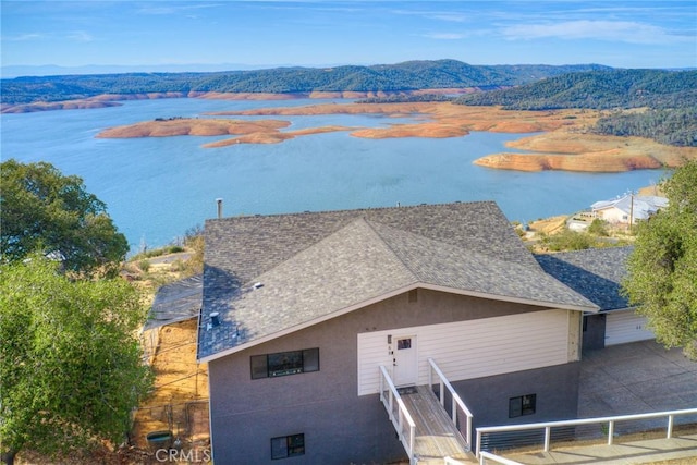 drone / aerial view with a water and mountain view