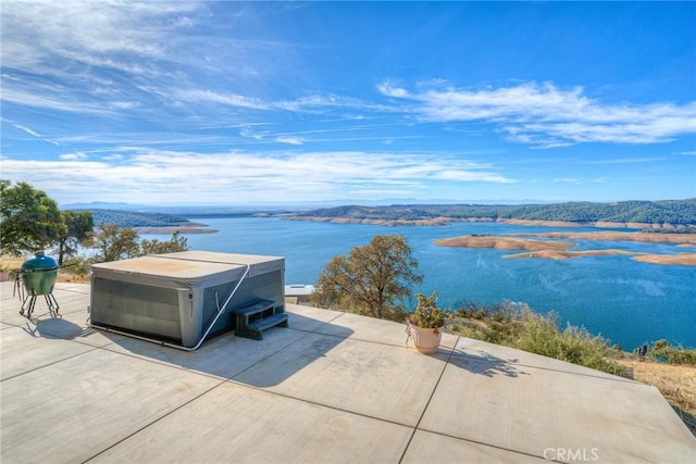 exterior space with a water and mountain view