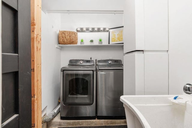 washroom with washing machine and dryer and sink