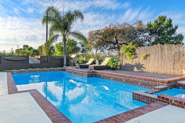 view of swimming pool featuring an in ground hot tub